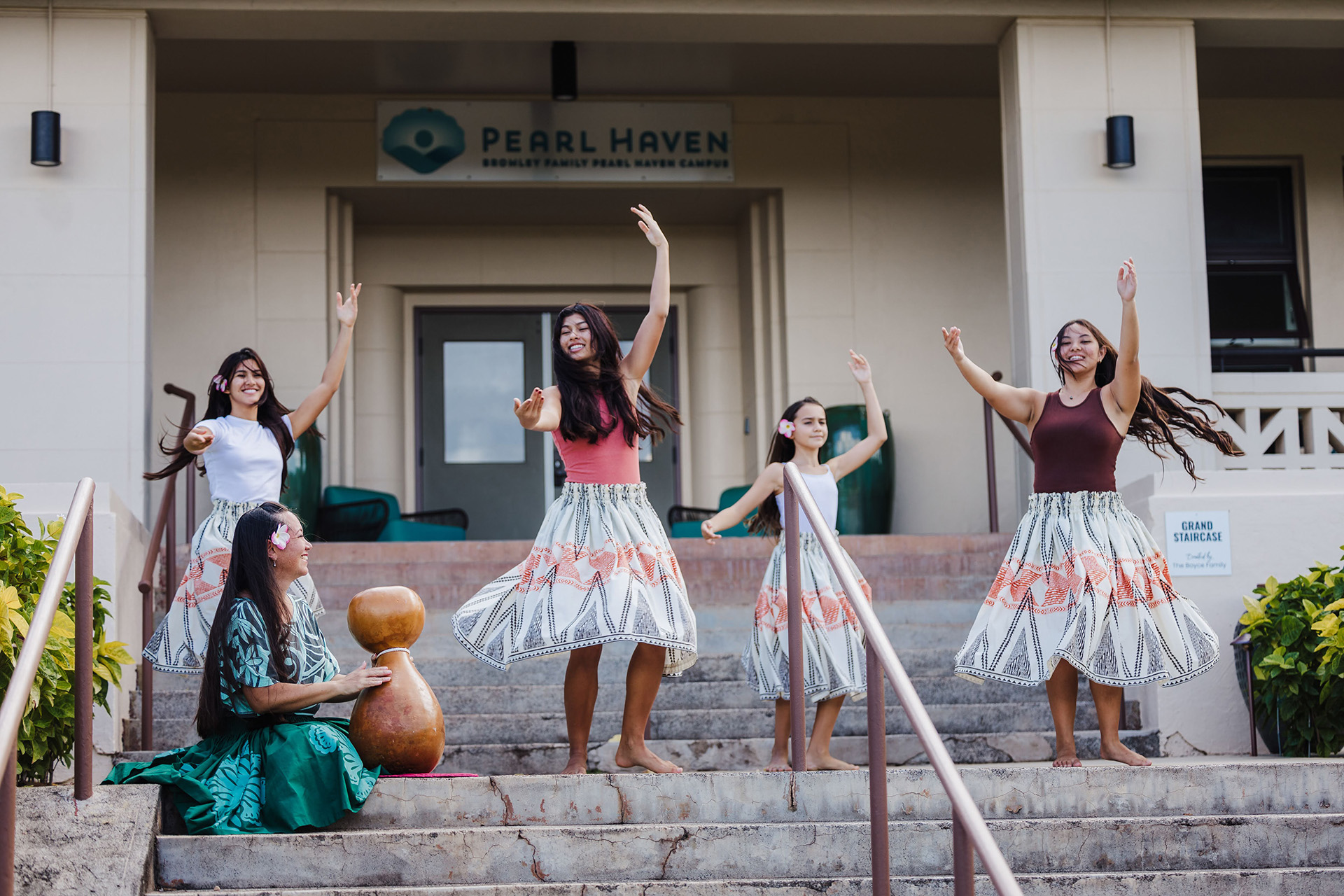 Participants dance in front of the Pearl Haven building.